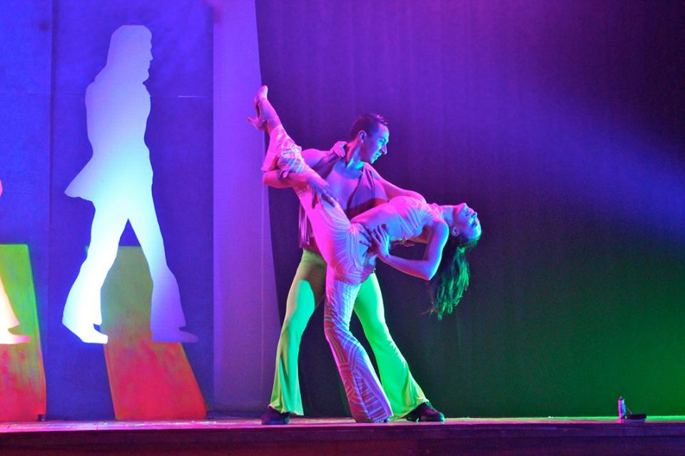 A male and female dancer performing on stage.