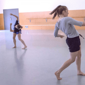Two female dancers dancing in a studio